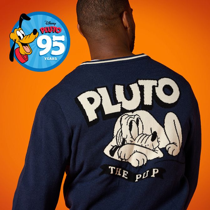 Person wearing a navy cardigan featuring Pluto lying down with 'Pluto The Pup' text. A 'Pluto 95 Years' logo is in the top right.