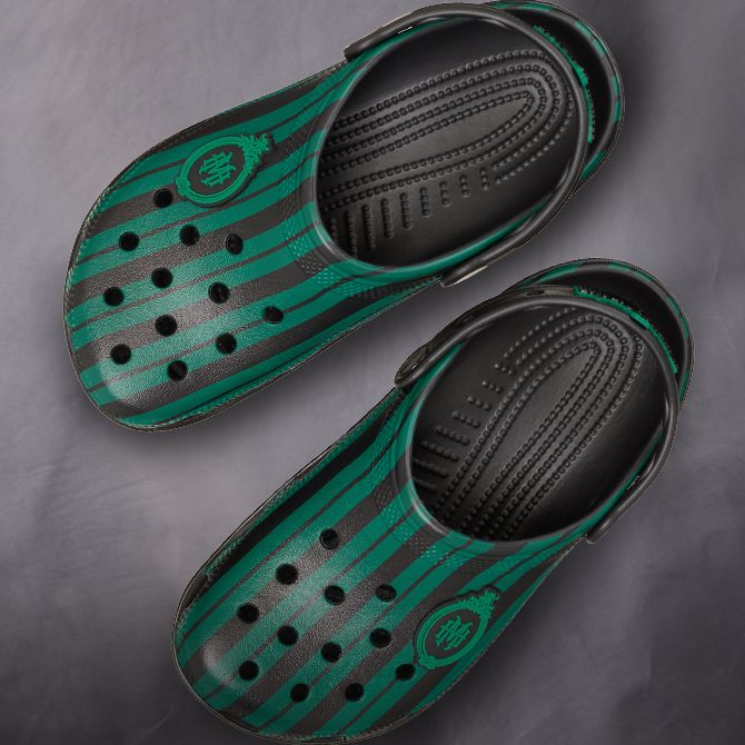 Eeyore-themed Crocs against an illustrated Hundred Acre Woods background. Text: Disney | Crocs.