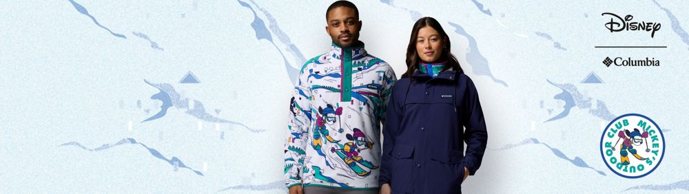 Two people modeling Columbia winter jackets; one featuring Disney-themed graphics with Mickey Mouse skiing, the other in solid navy blue.