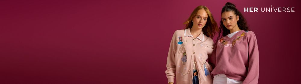 Two people wear red plaid shirts with Minnie Mouse holiday embroidery. Gift boxes and a decorated Christmas tree are in the background.