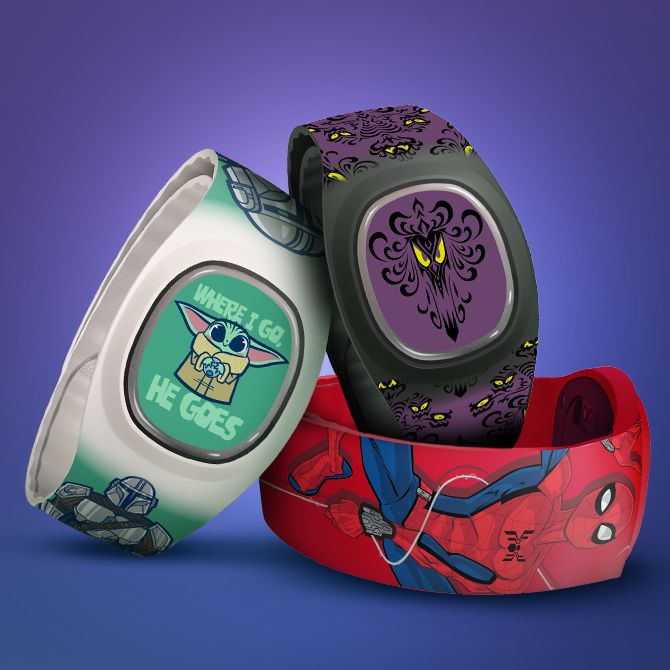 Grogu MagicBand, Spiderman MagicBand, and Haunted Mansion MagicBand on blue background